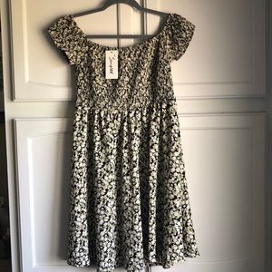 Simply off the shoulder smocked dress. Black ivory and tan flowers